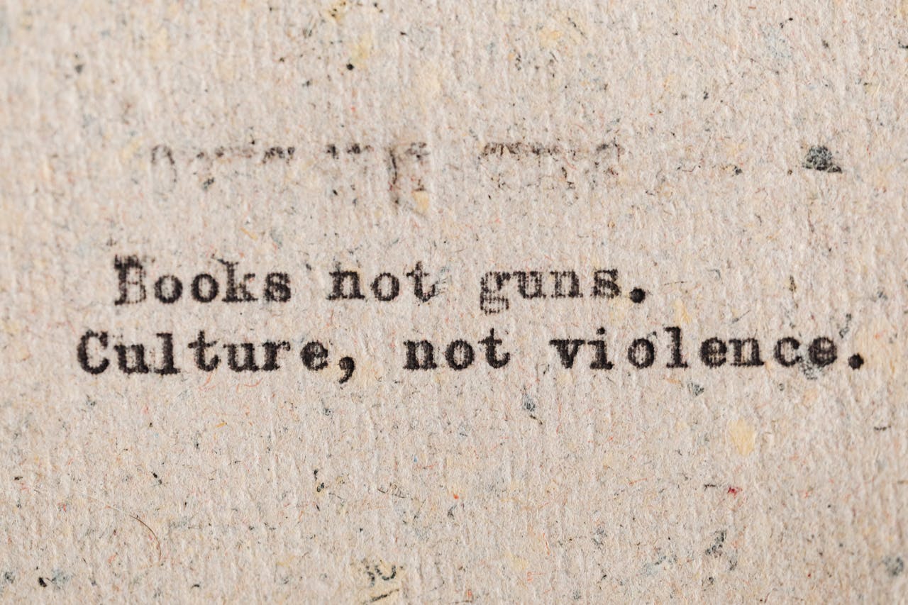 about-img-02 A vintage typewritten quote promoting culture over violence on aged paper.