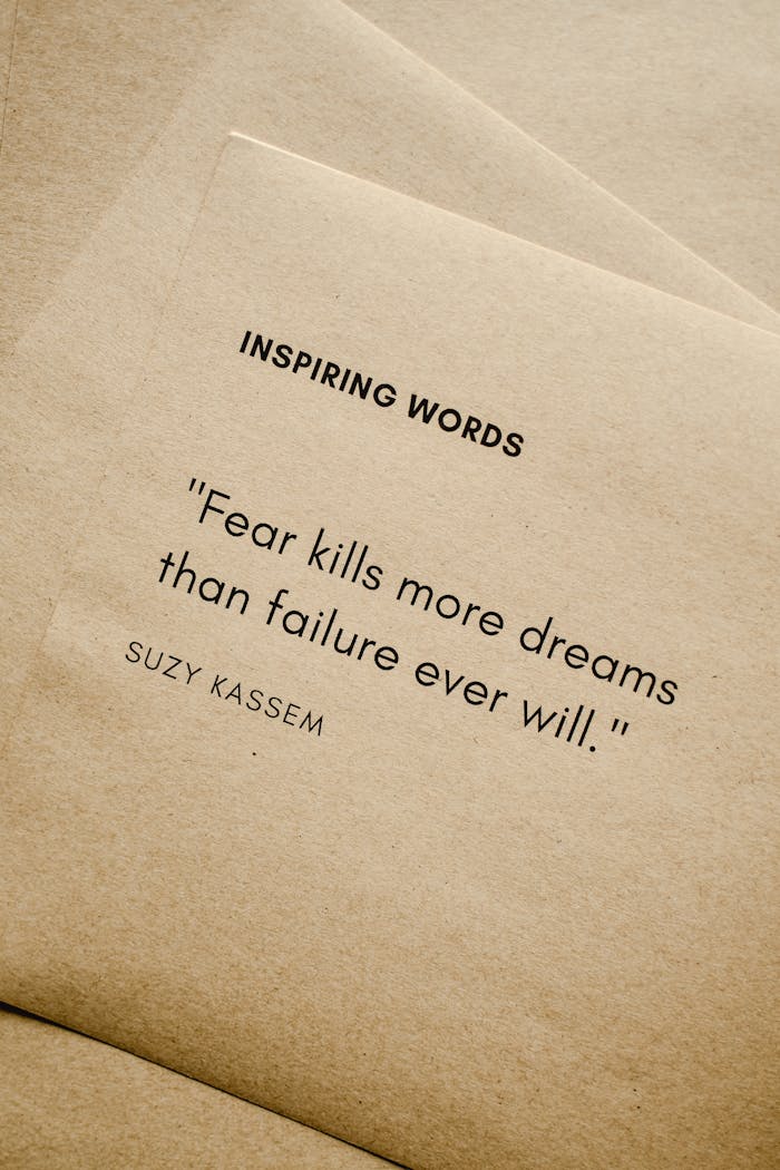 Crafting Captivating Headlines: Your awesome post title goes here Motivational quote 'Fear kills more dreams than failure ever will.' by Suzy Kassem on paper texture.